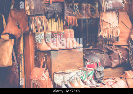 Moroccan leather goods bags and slippers at outdoor market in Marrakesh, Morocco. Stock Photo