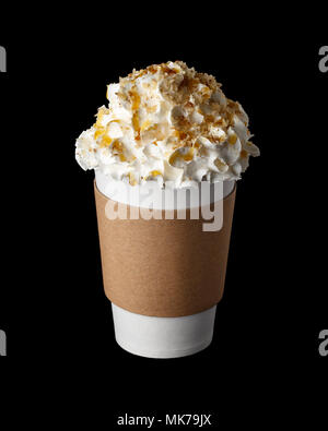 Coffee drink covered with whipped cream, caramel syrup and chopped peanuts in paper cup to go isolated on black background Stock Photo
