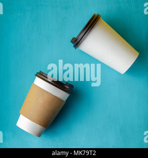 Take away coffee drink in disposable paper cup over turquoise wooden background Stock Photo