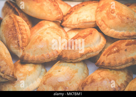 Traditional Empanadas stuffed with minced beef, pepper and corn, served with Aji Picante sauce Stock Photo