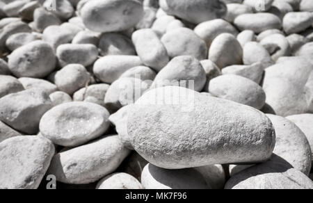 Close up picture of naturally polished white pebbles, selective focus. Stock Photo
