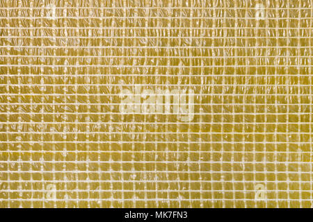 Square geometrical mosaic yellow film texture background.  Waterproofing layer of construction material. Wall damp course material Stock Photo