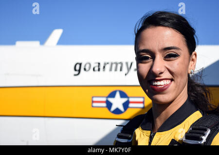 Washington Redskins are a National Football League franchise based in the Washington metropolitan area, rebranded as the Washington Commanders in 2022. The archival image records a team cheerleader preparing to board an aircraft with the U.S. Army Golden Knights Parachute Team for a tandem jump event on Nov. 22 at Tipton Airport near Fort George G. Meade, Maryland. Stock Photo