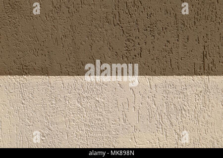 Close up outdoor view of a wall stone bricks corner. Half part of the wall is lighted by the sun, the other part is in the shadow. Pattern with beige  Stock Photo