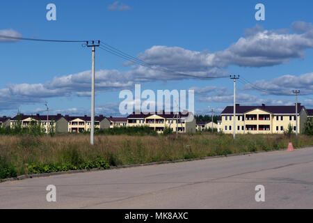 Yellow house in the garden against a dark blue sky Stock Photo