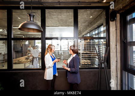 Bakery office with business women talking together Stock Photo