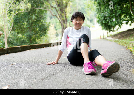 Senior woman resting after jogging Stock Photo