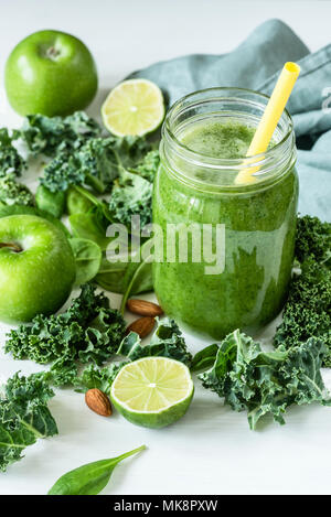 Green detox smoothie or blended juice in glass bottle on white. Smoothie with kale, broccoli, spinach, apple and lime. Green smoothie bottle. Concept  Stock Photo