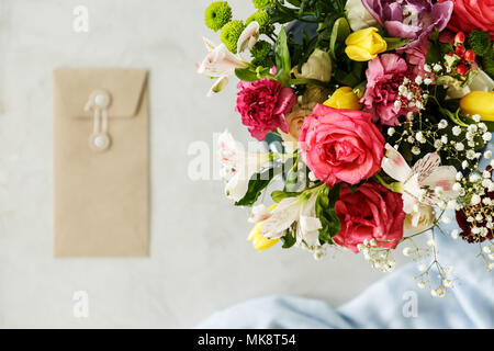 Close-up of bouquet of red roses, yellow tulips and white flowers on blurred background with copy space. Valentine's day concept Stock Photo
