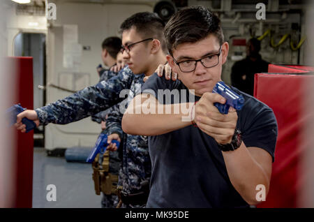 PORTLAND, Ore. (Oct. 30, 2017) Gunner’s Mate Seaman Leonardo Gonzalez leads a team during tactical team movement training in the Mark-48 shop aboard the submarine tender USS Frank Cable (AS 40), Oct. 30. Frank Cable, currently in Portland, Ore. for a scheduled dry-dock phase maintenance availability, conducts maintenance and support of submarines and surface vessels in the Indo-Asia-Pacific region. (U.S. Navy photo by Mass Communication Specialist 2nd Class Allen Michael McNair/Released) Stock Photo