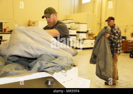 Workers assigned to the Fort McCoy Central Issue Facility handle cold-weather sleeping systems and equipment on November 27, 2017, at Fort McCoy, Wisconsin. The archival image documents Organizational Clothing and Individual Equipment management supporting U.S. Army Reserve training, including issuance of more than 387,000 items worth over $33 million during fiscal year 2017. Stock Photo