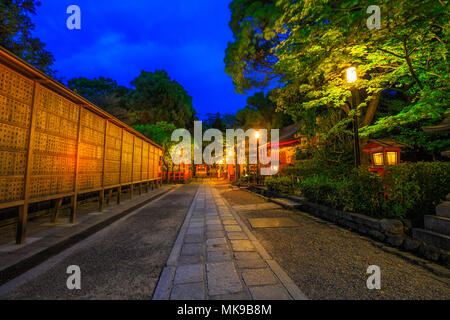 Kyoto, Japan - April 25, 2017: Illuminated path at dusk from Yasaka Shrine to the Gion weeping cherry tree in Maruyama Park. Gion Shrine is one of the most famous shrines in Kyoto, Japan . Stock Photo