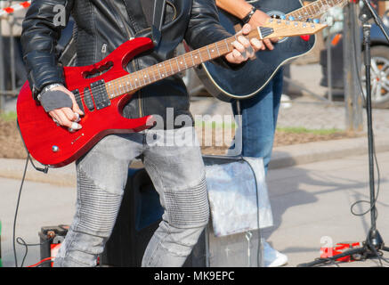 Street musicians playing on guitars. Unrecognizable persons. Stock Photo