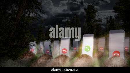 Phone addiction even after death. Cellphone addicted people concept. Graves with smartphones with glowing screens instead of a monument, panoramic vie Stock Photo