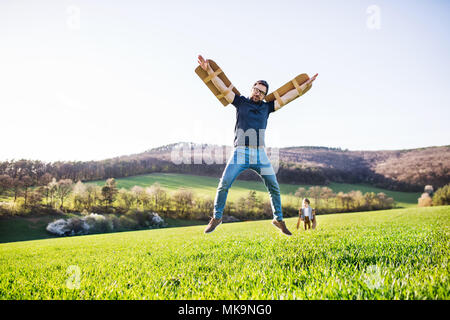 Happy toddler boy playing outside with father in spring nature. Stock Photo