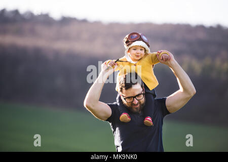 A father with his toddler daughter outside in spring nature. Stock Photo