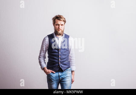 Portrait of a young hipster man in a studio. Copy space. Stock Photo