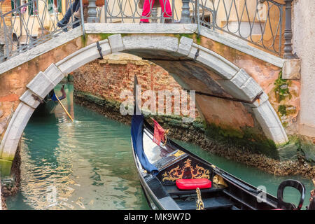 Venetian canal with gondola in Venice, Italy. Stock Photo