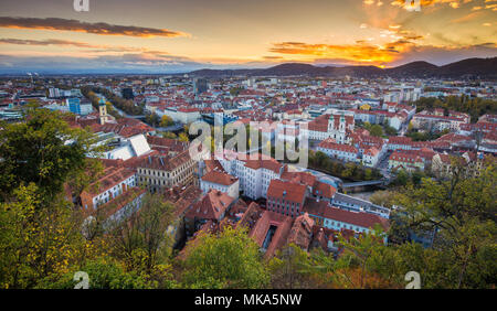 Panoramic aerial view of the old town of Graz from Grazer Schlossberg (castle hill) in beautiful golden evening light at sunset, Styria, Austria Stock Photo