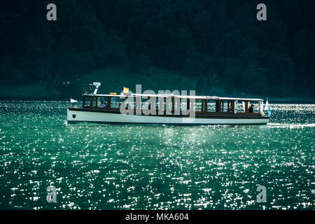 Classic view of traditional passenger boats on famous Lake Konigssee in beautiful evening light at sunset in summer, Berchtesgadener Land, Bavaria, Ge Stock Photo