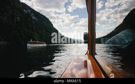 Classic view of traditional passenger boats on famous Lake Konigssee on a beautiful sunny day with blue sky and clouds in summer, Berchtesgadener Land Stock Photo
