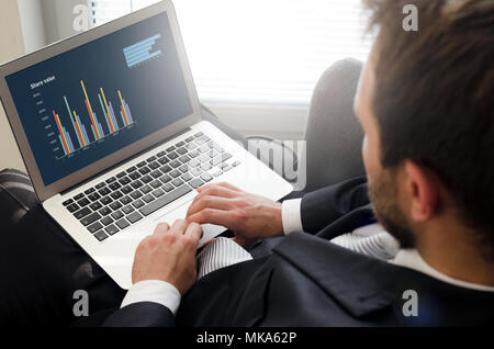 Analyst working with laptop. Computer statistics and diagrams concept Stock Photo