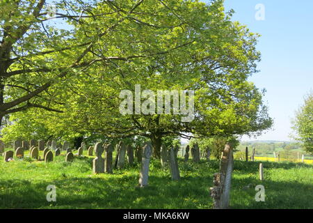 A beautiful scene of tranquillity and sunshine in a Northamptonshire country churchyard; St Mary's Church, Great Brington; early May Bank Holiday 2018 Stock Photo