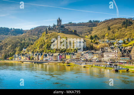 Beautiful view of the historic town of Cochem with famous Reichsburg castle on top of a hill and scenic Moselle river on a sunny day with blue sky and Stock Photo