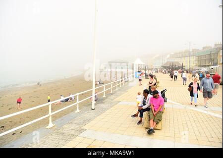 Aberystwyth  Wales UK, Monday 07 May 2018  UK Weather: People at the seaside in Aberystwyth enjoying the misty sunshine , on what is expected to be the hottest early May Bank Holiday Monday on record, with temperatures reaching 28ºc in parts of the south east of England   photo © Keith Morris / Alamy Live Newps Stock Photo