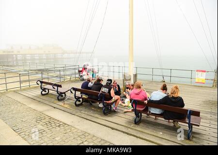 Aberystwyth  Wales UK, Monday 07 May 2018  UK Weather: People at the seaside in Aberystwyth enjoying the misty sunshine , on what is expected to be the hottest early May Bank Holiday Monday on record, with temperatures reaching 28ºc in parts of the south east of England   photo © Keith Morris / Alamy Live Newps Stock Photo