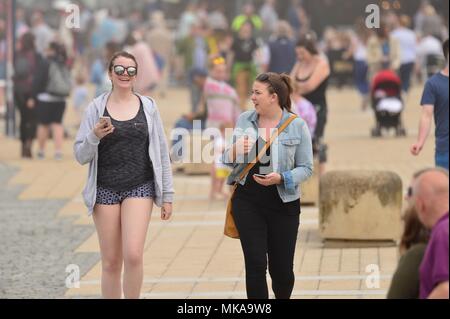 Aberystwyth  Wales UK, Monday 07 May 2018  UK Weather: People at the seaside in Aberystwyth enjoying the misty sunshine , on what is expected to be the hottest early May Bank Holiday Monday on record, with temperatures reaching 28ºc in parts of the south east of England   photo © Keith Morris / Alamy Live Newps Stock Photo