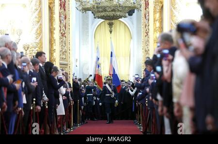 Moscow, Russia. 07th May, 2018. The Russian presidential guard escorts President Vladimir Putin as he arrives at the Kremlin Grand Palace to be sworn-in for the forth time as the President of the Russian Federation May 7, 2018 in Moscow, Russia. (Kremlin Pool via Credit: Planetpix/Alamy Live News Stock Photo