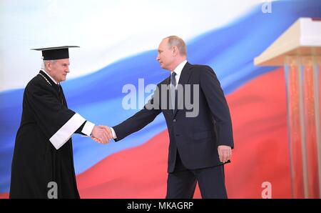 Moscow, Russia. 07th May, 2018. Russian Constitutional Court President Valery Zorkin, left, congratulates Russian President Vladimir Putin following the inauguration ceremony in the Kremlin Grand Palace May 7, 2018 in Moscow, Russia. Putin was sworn-in for the forth time as the President of the Russian Federation. (Kremlin Pool via Credit: Planetpix/Alamy Live News Stock Photo