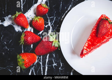 Red velvet cake with strawberries in a marble table Stock Photo