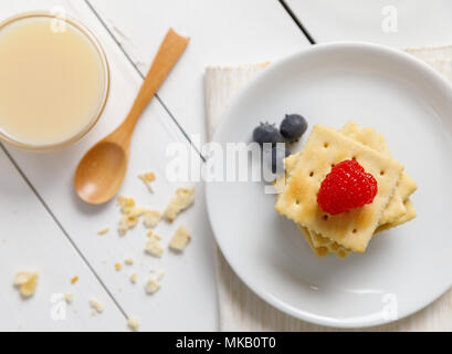 crackers with condensed milk and fruit, breakfast Stock Photo