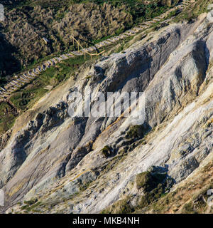 A band of weak clay rocks forms a landslip between harder limestone cliffs at Durdle Door, a popular tourist honeypot location on Dorset's Jurassic Co Stock Photo