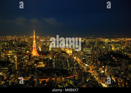 Aerial view of Tokyo Skyline at night with illuminated iconic Tokyo Tower in Minato District, Tokyo, Japan. Stock Photo