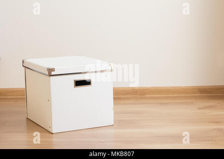 white box on the floor in empty room Stock Photo