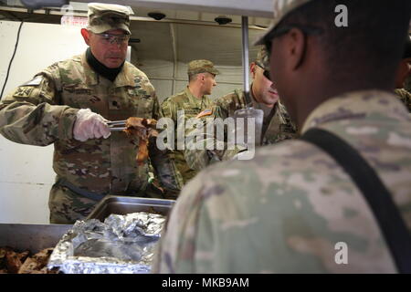 U.S. Army Lt. Col. Julian Urquidez, Commander of 2nd Battalion, 4th Field Artillery, 75th Fires Brigade, serves yams to his Soldier for a Thankgiving meal in South Korea on November 23, 2017. Thanksgiving gives Soldiers the opportunity to reflect on what they are thankful for during the holiday season with their fellow service members. (U.S. Army photo by Sgt. Brian Chaney) Stock Photo