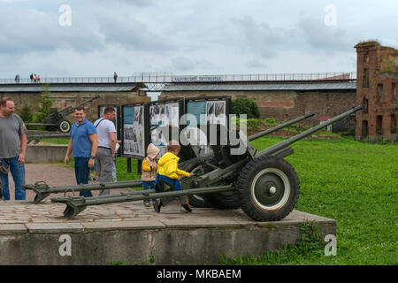 SHLISSELBURG, SAINT PETERSBURG, RUSSIA - AUGUST 21, 2017:Children inspect the gun. A fragment of the memorial to the defenders of the fortress Oreshek Stock Photo