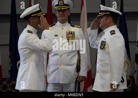 U.S. Navy Cmdr. Teague Suarez, right, off-going commanding officer ...