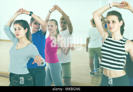 Group of positive american teen dancing salsa in dance studio Stock Photo