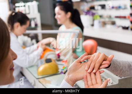 Woman hands in nail salon receiving professional manicure Stock Photo