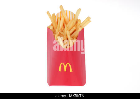 McDonald’s large french fries in red box container on white background Stock Photo