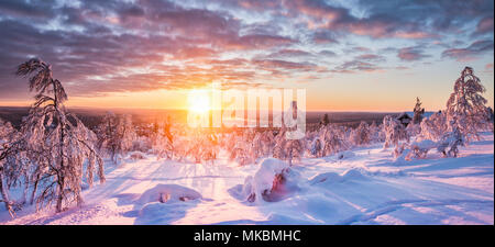 Panoramic view of beautiful winter wonderland scenery in scenic golden evening light at sunset with clouds in Scandinavia, northern Europe Stock Photo