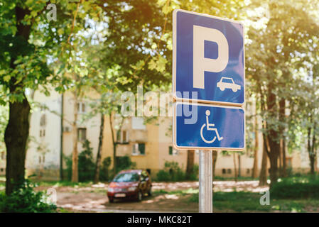 Handicap parking spot sign, reserved lot space for disabled person, selective focus Stock Photo