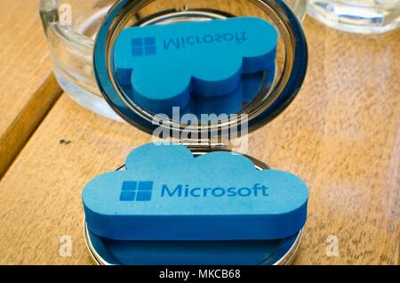 Nis, Serbia, April 24, 2018:  Icon Microsoft Windows OneDrive on small round mirror with reflection on wooden table Stock Photo