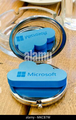 Nis, Serbia, April 24, 2018:  Icon Microsoft Windows OneDrive on small round mirror with reflection on wooden table Stock Photo