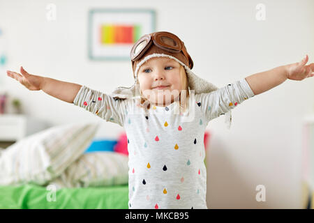 happy little girl in pilot hat playing at home Stock Photo