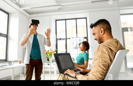 developers with virtual reality headset at office Stock Photo